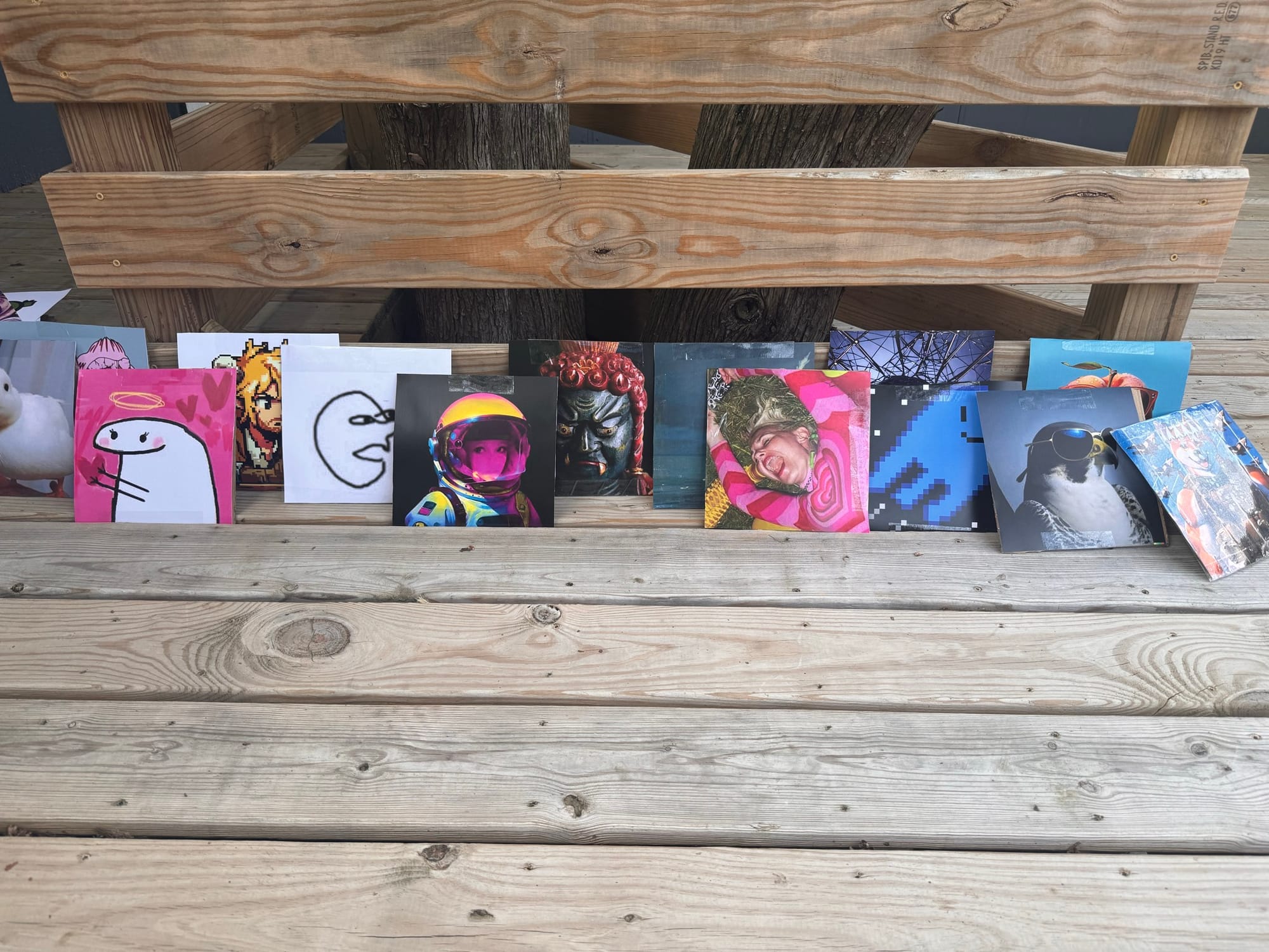 Album cover artwork on a wooden bench